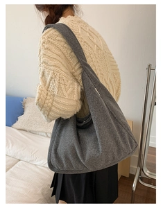 Detail of grey felt hobo shoulder bag with a soft texture for autumn and winter