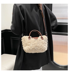 Detail of plush lambskin-like small square bag with brown leather flap and silver buckle