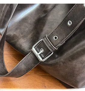 Detailed macro view of vintage brown leather strap with silver metallic buckle and eyelets