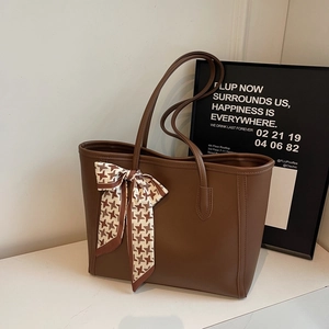 Large coffee brown tote bag with houndscarf ribbon on minimalist white marble background