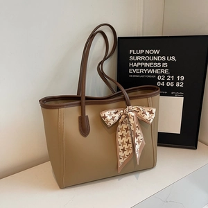 Minimalist large tote bag with contrast brown trim and houndstooth scarf on white marble