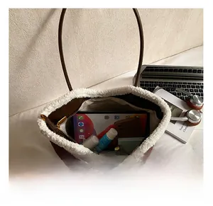 Top view of brown suede tote bag interior showing spacious storage for gadgets