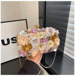 Macro detail of 3D floral embroidery with pearls and rhinestones on the evening bag