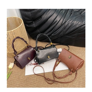 Three vintage oil wax leather handbags in burgundy black and brown with knot handles