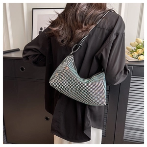 Back view of model wearing a sparkling rhinestone crescent bag with black leather strap