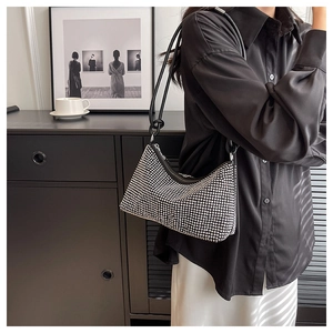 Fashionable black baguette bag with shiny silver rhinestones and slender leather strap