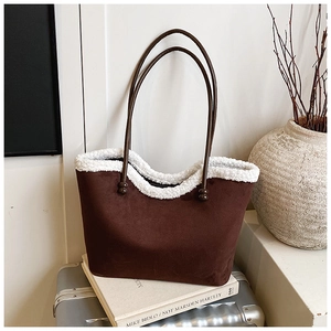 Detail of coffee suede tote bag with white faux shearling trim and slim handles
