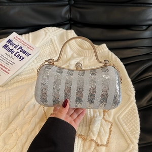 Elegant silver sequin evening bag with gold handle and sparkling diamond clasp detail