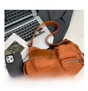 Detailed view of caramel vintage crossbody bag with functional multi-pockets and matte texture