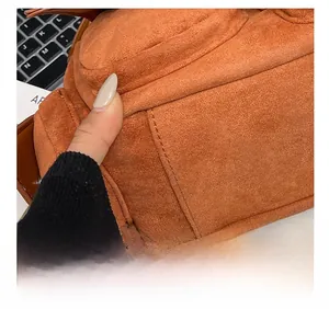 Detailed macro shot of fine stitching on caramel suede leather shoulder bag surface