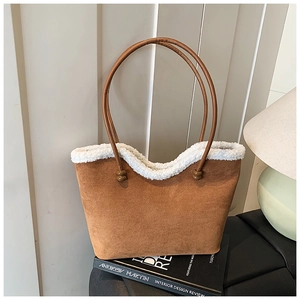 Brown suede tote bag with white faux fur trim shown in a cozy interior design setting