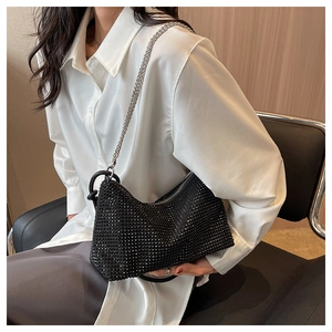 Chic black rhinestone hobo bag with silver chain worn with a white shirt and dark skirt