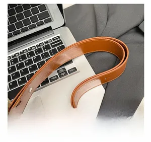 Close-up of brown faux leather shoulder strap with neat stitching on a designer bag