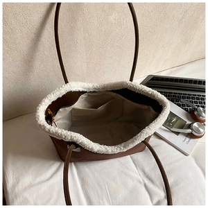 Macro shot of faux suede tote bag interior with white fleece trim and slim handles