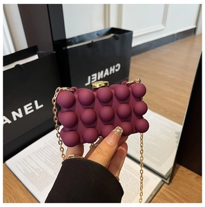 Close-up of wine red acrylic box bag with 3D bubble texture and gold chain strap