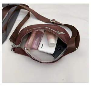 Internal view of brown crescent bag capacity with power bank and cosmetics