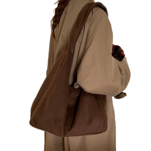 Minimalist deep brown suede tote bag for women worn by a model in autumn attire