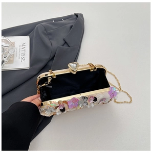 Detailed interior of the sequin floral evening bag with its elegant golden metal chain