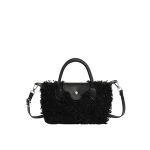 Chic black plush faux lamb wool handbag with smooth leather trim and adjustable strap