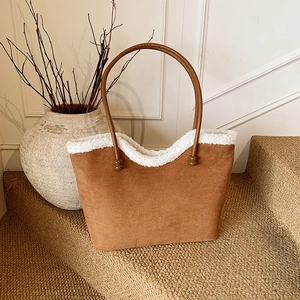 Vintage brown suede tote bag with white faux shearling trim on a sisal staircase