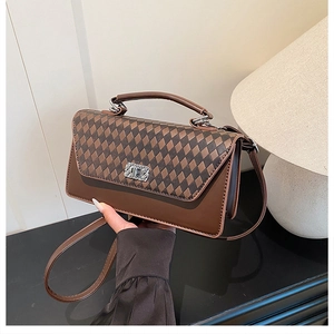 Close-up of retro contrast crossbody bag with rhombus pattern and silver buckle detail