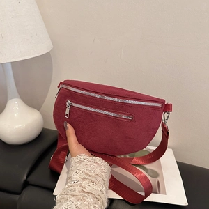 Red faux suede chest bag with wide nylon strap and double silver metal zippers