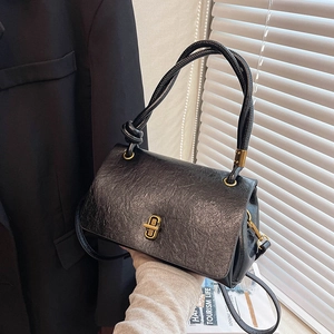 Vintage black oil-wax leather handbag with gold twist lock and adjustable shoulder strap