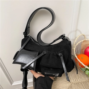 Minimalist black multi-pocket shoulder bag in matte suede and leather patchwork style