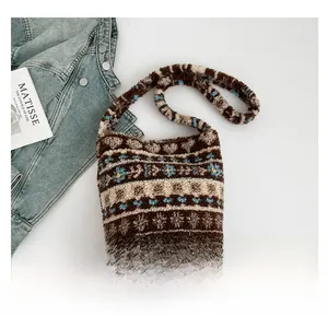 Detail of plush brown shoulder bag featuring ethnic geometric patterns and soft texture