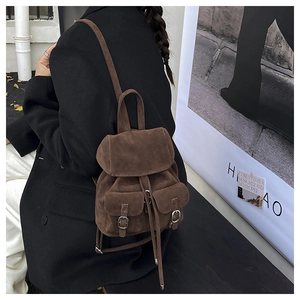 Detailed back view of vintage brown suede mini backpack with adjustable straps and buckles
