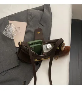 Top view showing the spacious interior of the brown crossbody bag with daily essentials
