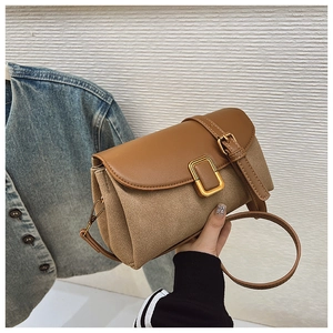 Detail of vintage patchwork crossbody bag featuring brown leather and khaki suede finish