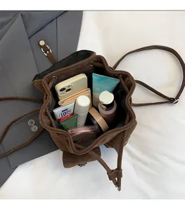Brown faux suede backpack interior showing large capacity for phone and cosmetics