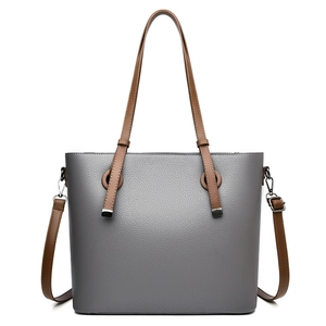 Minimalist grey pebbled leather tote bag with brown straps and metal buckle accent