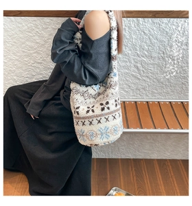 Detail of plush lamb wool shoulder bag with vintage snowflake jacquard pattern and texture