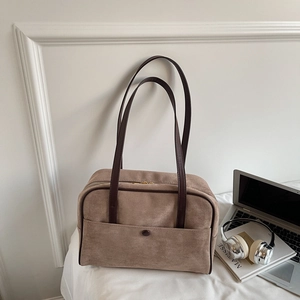 Vintage coffee brown suede shoulder bag for women with leather handles on a white background