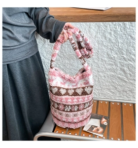Close-up of pink plush tote bag with heart pattern and soft faux fur texture detail