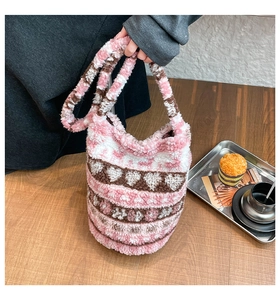 Detail of plush tote bag showing pink heart pattern and soft faux fur texture
