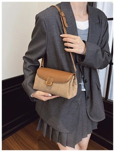 Detail of vintage square crossbody bag featuring two-tone leather and gold clasp