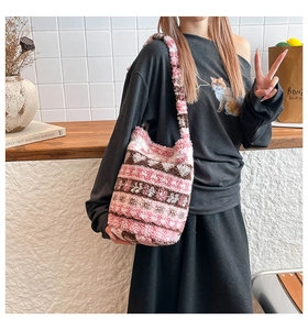 Detail of pink and white checkered plush shoulder bag with soft fleece texture and wide strap