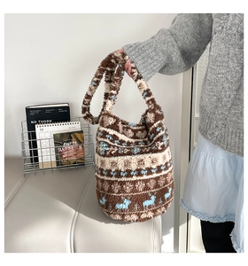 Close-up of plush tote bag featuring Nordic deer patterns and textured faux shearling