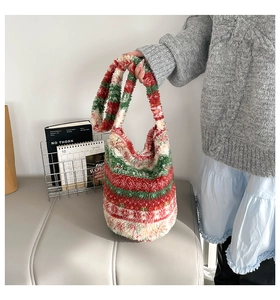 Detail of plush striped handbag showing soft texture and colorful red, green, white patterns