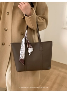 Detail of dark brown tote bag with decorative printed scarf and reinforced stitching
