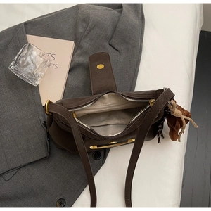 Brown suede crossbody bag with vintage hardware and cute plush bear charm