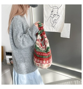 Detail of plush tricolor patchwork handbag with soft faux shearling lamb wool texture