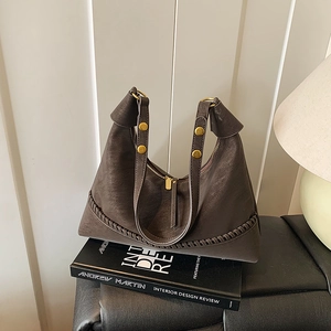 Retro dark brown leather dumpling shoulder bag with woven stitching and gold rivets