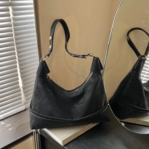 Chic black synthetic leather hobo bag with gold hardware and woven bottom trim details