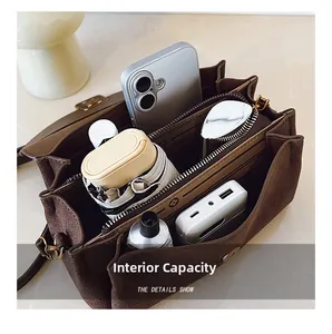 Interior view of brown suede shoulder bag showing large capacity and multi-compartment storage
