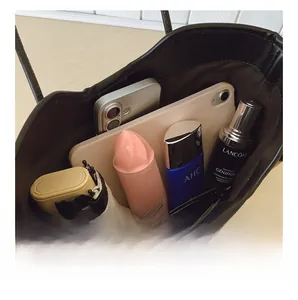Spacious interior of a brown tote bag showing capacity for tablet, phone, and daily essentials