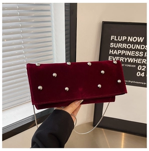 Burgundy velvet crossbody bag with silver studs and chain strap in a stylish square design
